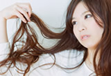 髪の毛を持ち上げる女性